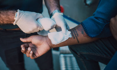 Healthcare professional bandaging an injured arm